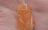 Orange calcite pendant wire wrapped in sterling silver