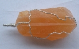 Orange calcite pendant wire wrapped in sterling silver
