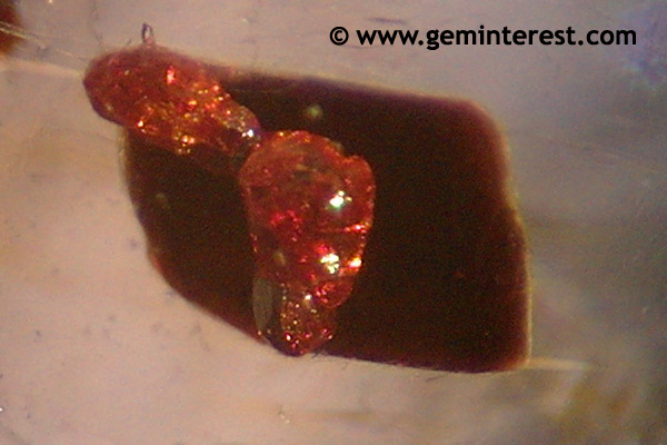 “red brown rutile crystals” inclusions